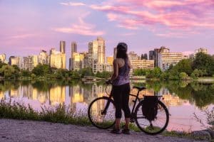 West Canada BC Vancouver fietser bij meer met skyline bij zonsondergang